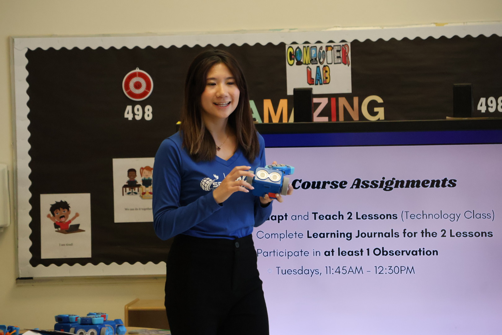 Kitty facilitating the Botley teacher training while holding a Botley robot